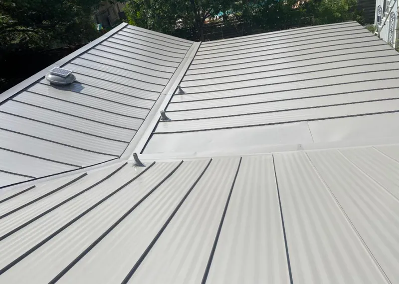 Solar attic fan installed on a metal roof for Roof Ventilation in Bennington